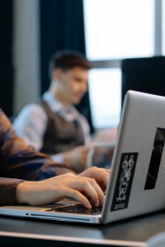 Close-up of Office Workers Sitting at the Desks and Using Computers